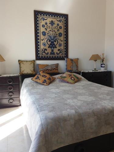 a bedroom with a large bed with pillows on it at Casa Sol in Carrapateira