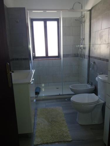 a bathroom with a toilet and a tub and a sink at Casa Sol in Carrapateira