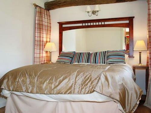 A bed or beds in a room at Cart Shed 