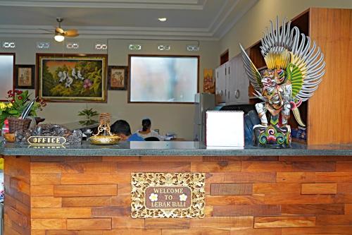 a counter at a restaurant with a statue at Lebak Bali Residence in Canggu