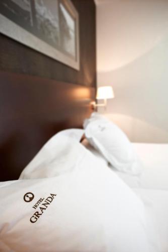 Un ou plusieurs lits dans un hébergement de l'établissement Hotel Granda