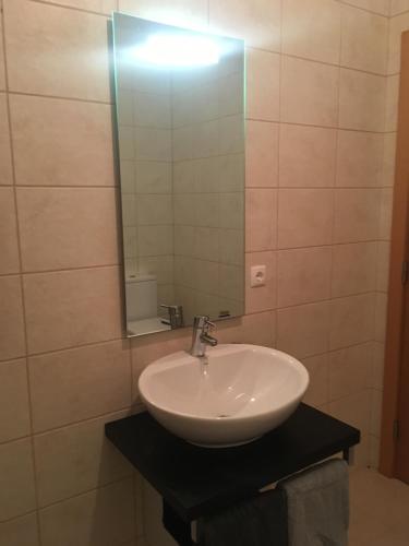 a bathroom with a sink and a mirror at casa de praia Nunes Village in Porto Santo
