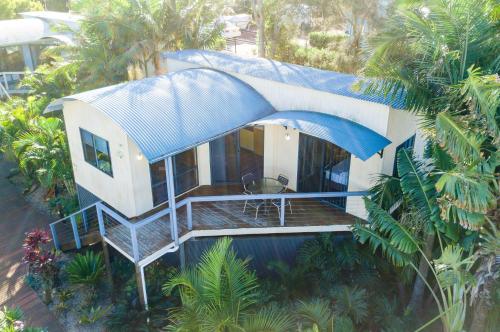 an aerial view of a house with a blue roof at Thou Walla Sunset Retreat in Soldiers Point