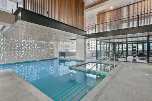 a large swimming pool in a large room at Hope Street Apartments by CLLIX in Brisbane
