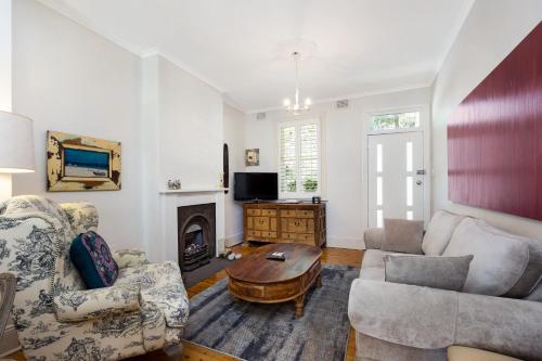 a living room with a couch and a coffee table at Pyrmont Self-Contained Terrace House (64 BUL) in Sydney