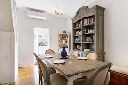 a dining room with a wooden table and chairs at Pyrmont Self-Contained Terrace House (64 BUL) in Sydney