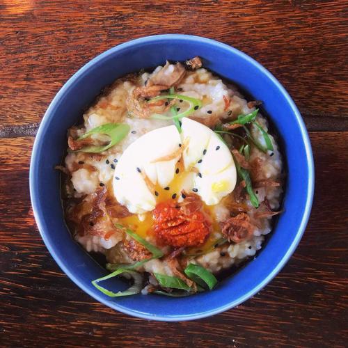 a blue bowl of food with an egg on top at Rawa Lombok in Kuta Lombok