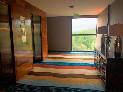a hallway with a window and a colorful striped floor at Summit Rainforest Golf Resort & All Inclusive in Paraíso
