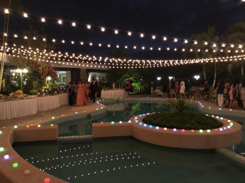 a wedding reception with lights and a swimming pool at Summit Rainforest Golf Resort & All Inclusive in Paraíso