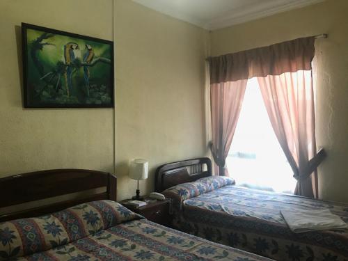En eller flere senge i et værelse på Hostal Don Nabil