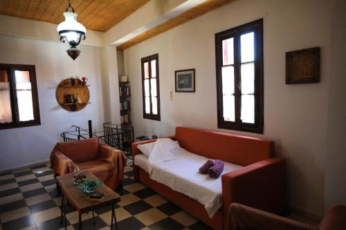 a living room with a couch and a chair at Kaldi's Traditional House in Kastamonítsa
