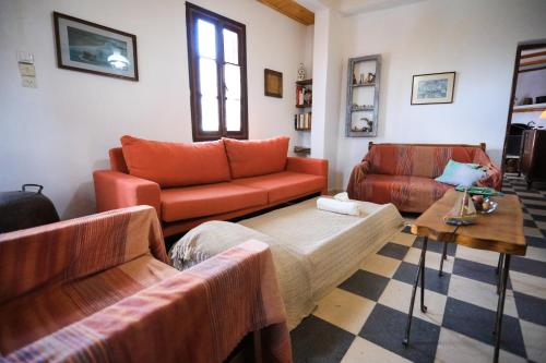 a living room with two couches and a table at Kaldi's Traditional House in Kastamonítsa