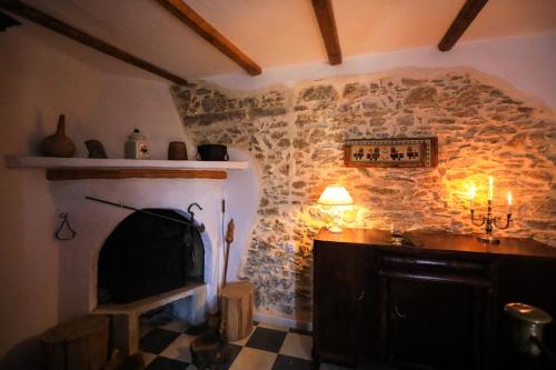 a room with a stone wall with a fireplace at Kaldi's Traditional House in Kastamonítsa