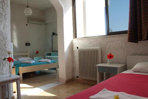 a bedroom with two beds and a window at Esperides Hotel in Myrtos