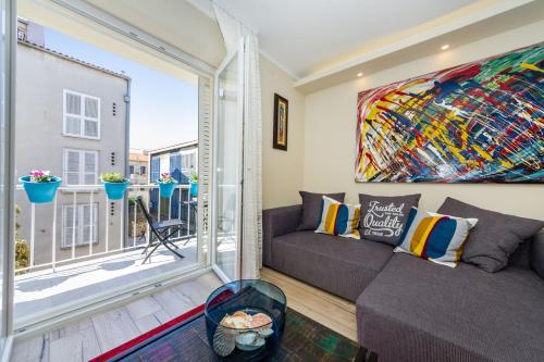 a living room with a couch and a large window at Ema 2BR apt. in old town centre in Zadar
