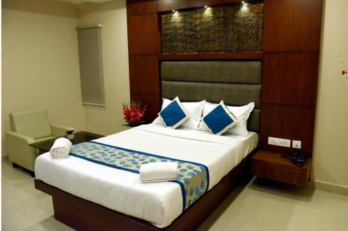 a bedroom with a large bed and a chair at The Hydel Park - Business Class Hotel - Near Central Railway Station in Chennai