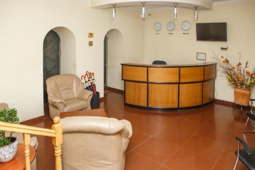 a waiting room with a desk and chairs at Hotel Nata in Tbilisi City