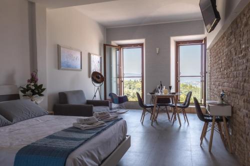 a bedroom with a bed and a table and chairs at Note di Rame in Castelfidardo
