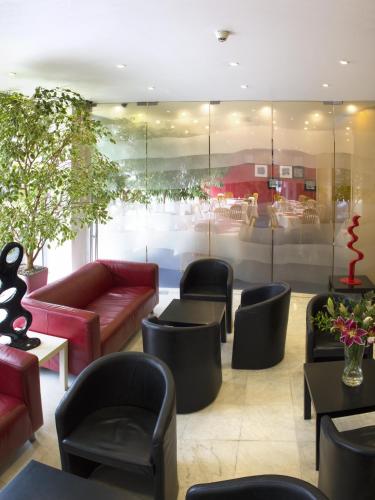 a lobby with couches and chairs and a table at Luxury Family Hotel Bílá Labuť in Prague
