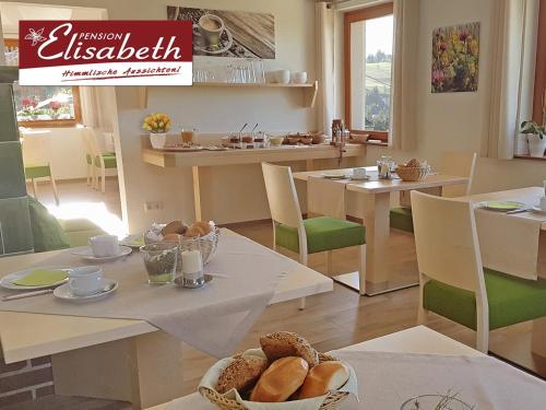 a dining room with a table with bread on it at Pension Elisabeth in Todtnauberg