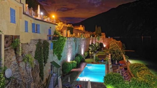 a resort with a swimming pool and a waterfall at Villa Romantica Hotel in Limone sul Garda