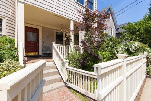 a white fence in front of a house at Charming Harvard Victorian in Cambridge