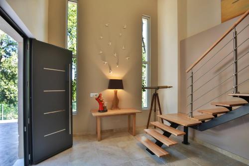 a staircase in a house with a door and a lamp at la villa miel in Opio