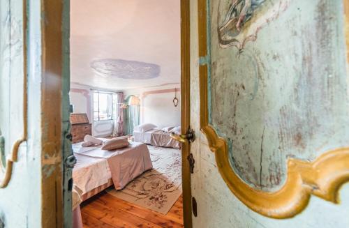 an open door to a bedroom with a bed at Villa De Rubeis Florit in Tarcento