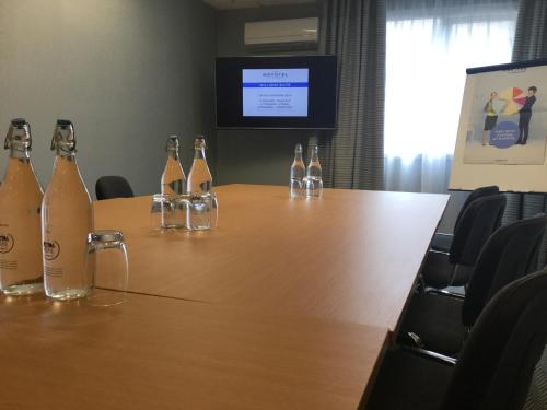 a group of bottles of wine sitting on a table at Novotel Manchester West in Worsley