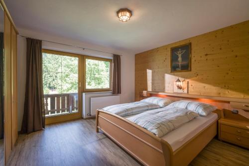 a bedroom with a bed and a large window at Haus Moidl in Stummerberg