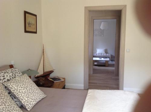 a bedroom with a bed and a door leading to a bathroom at la villa miel in Opio