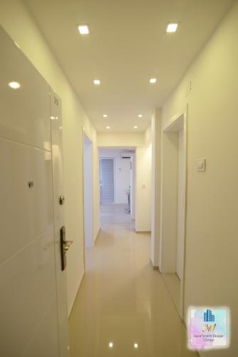 a hallway of an office building with a door at 3M Apartment Skopje Center in Skopje