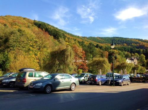 a bunch of cars parked in a parking lot at Le Baron Apartments in Stavelot