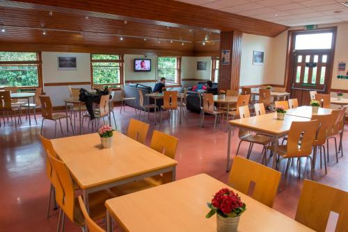 
a large room with tables and chairs and a table full of people at Stirling Youth Hostel in Stirling
