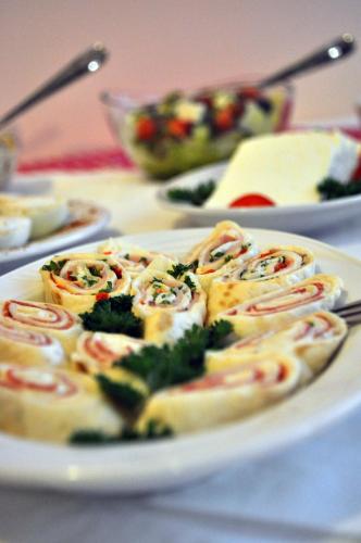 a white plate of food on a table at Hotel Platinum Hrubieszów in Hrubieszów