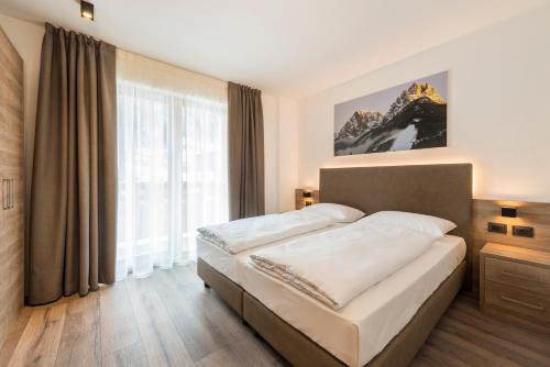 Ein Bett oder Betten in einem Zimmer der Unterkunft CIMA 11 & SASS PORDOI - Apartments