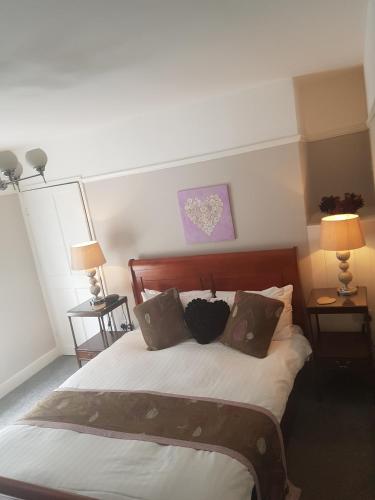 a bedroom with a bed with three pillows on it at The Boathouse in Sutton Bridge