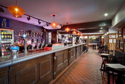 a bar with a long counter in a restaurant at Royal Oak Hotel in Betws-y-coed