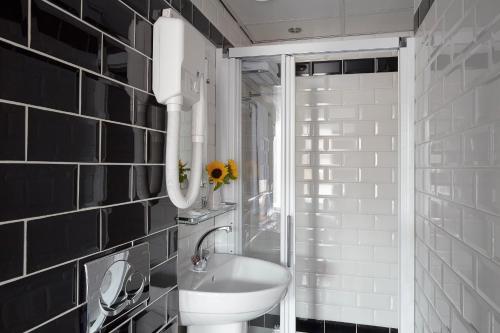 a bathroom with a sink and a toilet in it at Hotel D'Amsterdam Leidsesquare in Amsterdam