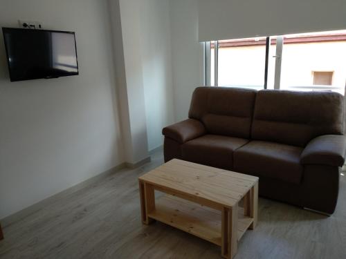 a living room with a couch and a coffee table at Apartaments Can Fabul in Sant Carles de la Ràpita