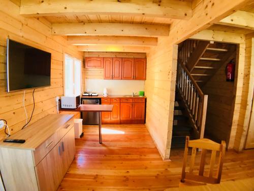 - une cuisine avec un escalier dans une cabane en rondins dans l'établissement Domki letniskowe Azalia, à Ustronie Morskie