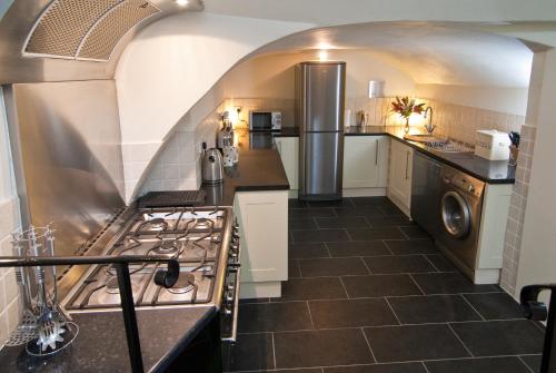 a kitchen with a sink and a stove top oven at The Paragon Townhouse in Bath