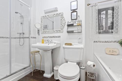 a bathroom with a toilet and a sink and a shower at Mama’s Inn Boutique Guest House in Nottingham
