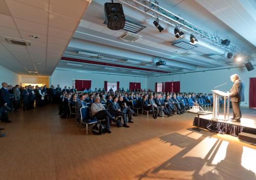 a man standing at a podium in a room with a crowd of people at TH Lazise - Hotel Parchi Del Garda in Lazise