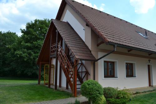 a house with a staircase and a roof at Penzion Nad Oborou in Hradec Králové
