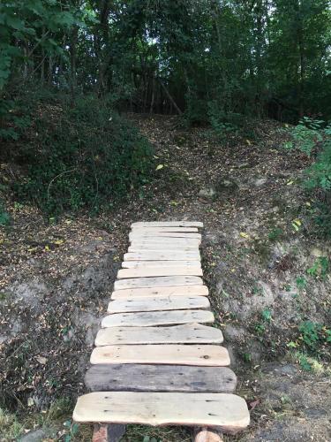 a wooden pathway in the middle of a field at Villa Baronzola in Montevarchi
