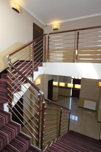 a staircase in a building with a stair railing at Fisherman's House in Ustka