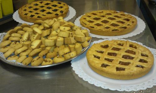 three pies and waffles on plates on a table at Hotel Giannino in Porto Recanati