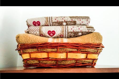 a stack of blankets and pillows on a table at L'Atelier du Temps - PanoramAlps Apartment in Courmayeur