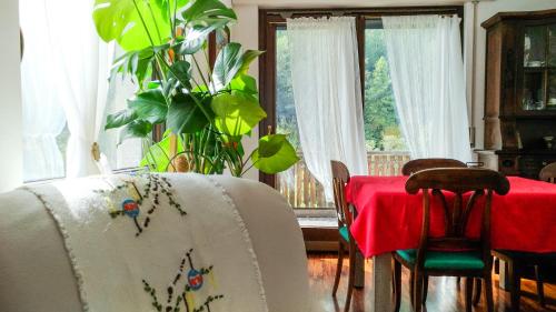 a dining room with a table with a red table cloth at L'Atelier du Temps - PanoramAlps Apartment in Courmayeur
